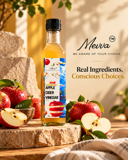 Mevva apple cider vinegar bottle on a stone platform surrounded by fresh red apples